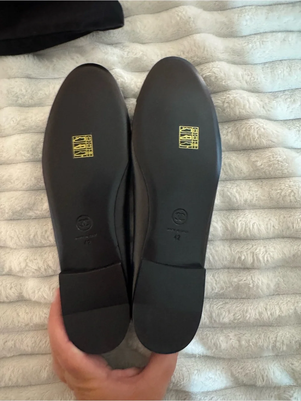 CHANEL Black Leather Ballet Flats with Patent Cap Toe and Bow Accent